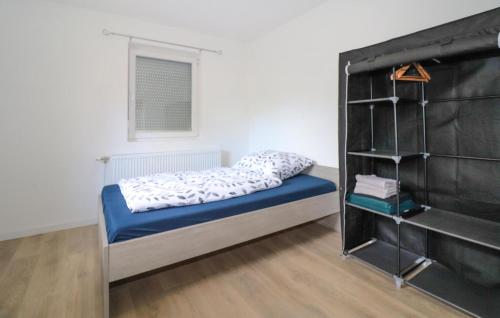 a small bedroom with a bed and a book shelf at Ferienwohnung - Rosenbach in Rosenbach