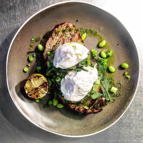 a plate of food with an egg and vegetables at Fabulous Beach Pad Just 20 Paces From The Sea in Mawgan Porth