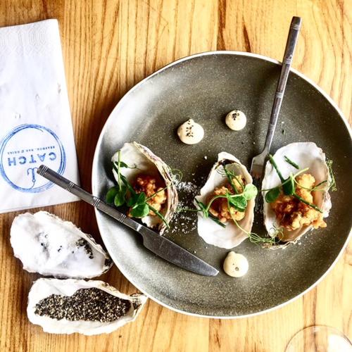 a plate of food with oysters on a table at Fabulous Beach Pad Just 20 Paces From The Sea in Mawgan Porth