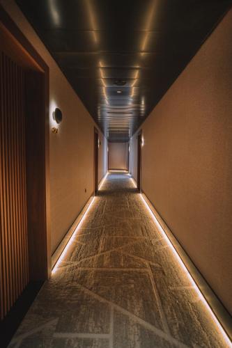 a long hallway with a long aisle with lights at Hotel Pinar Plaza in Madrid