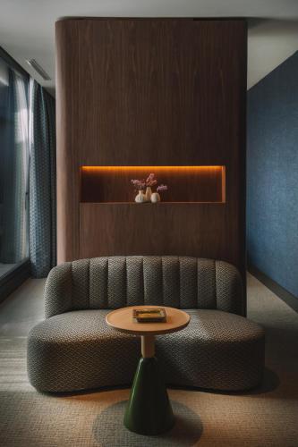 a living room with a couch and a table at Hotel Pinar Plaza in Madrid