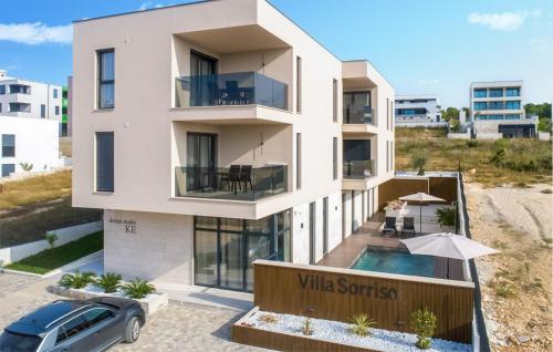 a house on the beach with a car parked in front at Nice Apartment In Sveti Filip I Jakov in Sveti Filip i Jakov