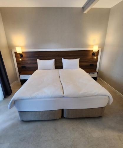 a bedroom with a large white bed with two pillows at Lulubay Rooms & Suites in Kusadası