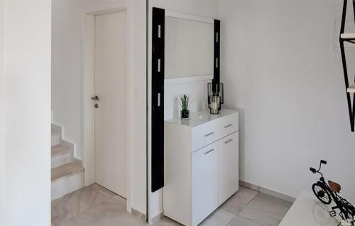 uma cozinha com paredes brancas e um armário branco em Beautiful Home In Musales With Outdoor Swimming Pool em Mušalež