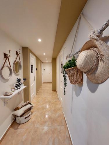 a hallway of a home with plants and baskets at Pensión Cabezas in Lugones