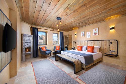 a bedroom with a bed and a tv in a room at Breeze Of Cappadocia in Nevsehir