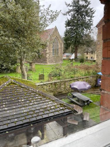 an outside view of a church with an umbrella at The bucks head hotel in Church Stretton