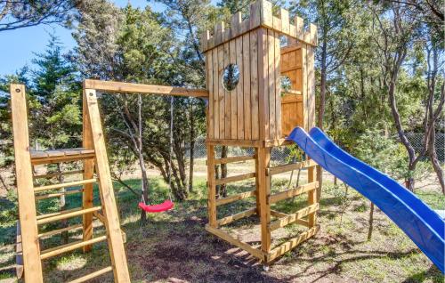 a wooden playground with a swing and a slide at 1 Bedroom Amazing Home In Cunski in Cunski