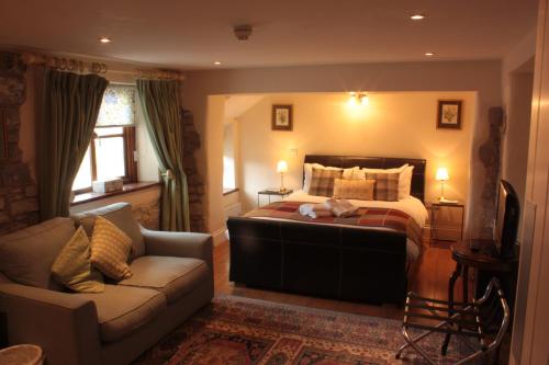 a bedroom with a bed and a couch at Farmers Arms in Taunton