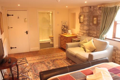 a living room with a couch and a chair at Farmers Arms in Taunton