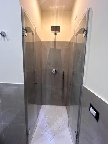 a shower with a glass door in a bathroom at Amaris in Palermo