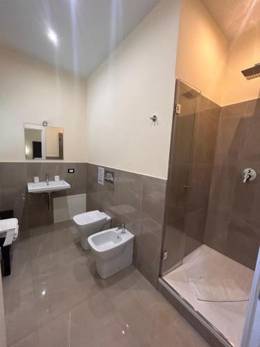a bathroom with a toilet and a shower and a sink at Amaris in Palermo