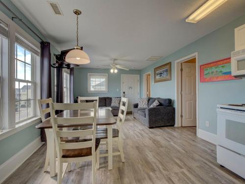 a dining room and living room with a table and chairs at Unit 216S at Tiffany's in Surf City