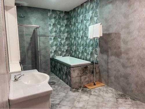 a bathroom with a sink and a shower and a toilet at Manee Poolvilla in Khanom