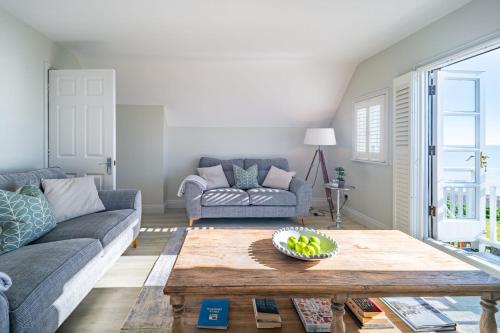 a living room with a couch and a table at 4 Truman Lodge in Thorpeness