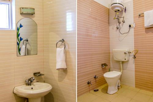 a bathroom with a toilet and a sink at Greenwoods Inn Mcleodganj #Parking #lift #All Balcony Rooms #Rooftop Terrace #Prime Location in McLeod Ganj
