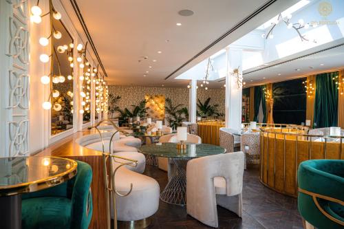 a restaurant with tables and chairs and a bar at The Delborough Lagos in Lagos