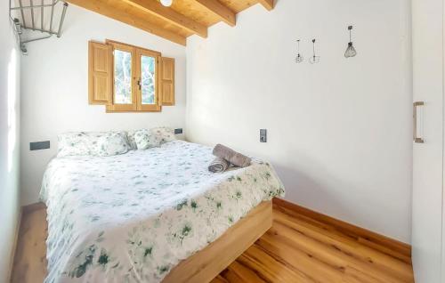 a bedroom with a bed with a floral bedspread at Beautiful stacaravan In Xtiva With Kitchenette in Xàtiva