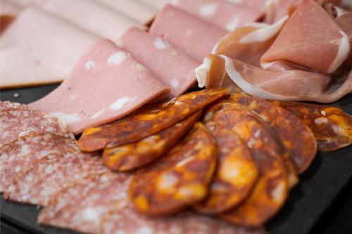a tray of food with sausage and bread and meat at Acropolis Select in Athens