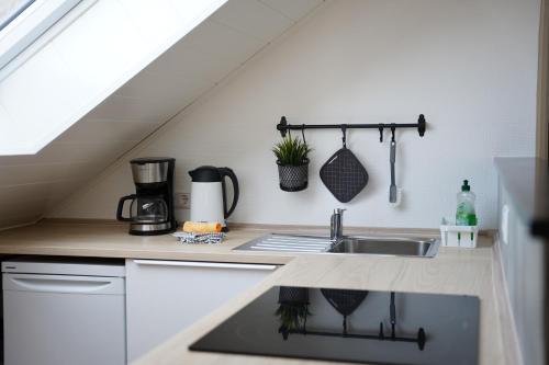 a kitchen with a sink and a counter top at Ferienhaus Am Reilsbach in Cochem