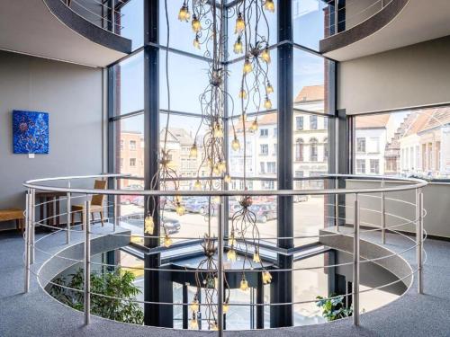 a spiral staircase in a building with a large window at Budget Rooms by Ghent River in Ghent
