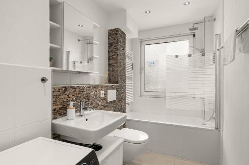a white bathroom with a sink and a toilet at FREE LIVING - Jungle Design Apartments, Zentrum, Parkplatz, Küche, Wlan in Wolfsburg
