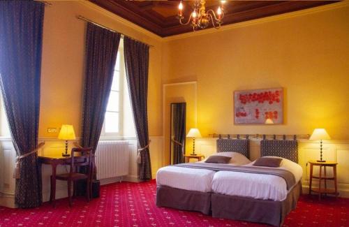 a bedroom with a large bed and two windows at Camping et Hotel Château du Haget in Montesquiou