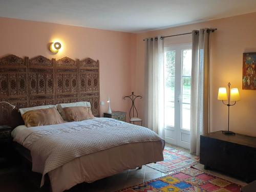 une chambre avec un grand lit et une grande fenêtre dans l'établissement Maison spacieuse pour 9 avec grand jardin, proche plage des Grands Sables! - FR-1-418-18, à Locmaria