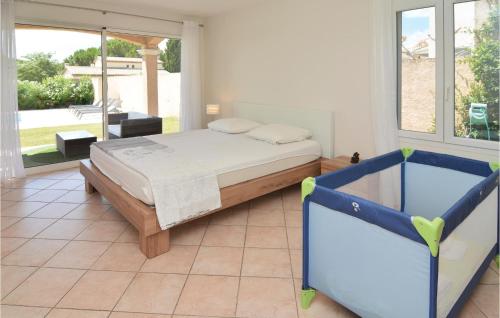 a bedroom with a bed and a large window at 4 Bedroom Beautiful Home In Calvisson in Calvisson