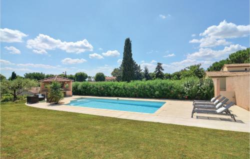 a swimming pool in a yard with two lounge chairs at 4 Bedroom Beautiful Home In Calvisson in Calvisson