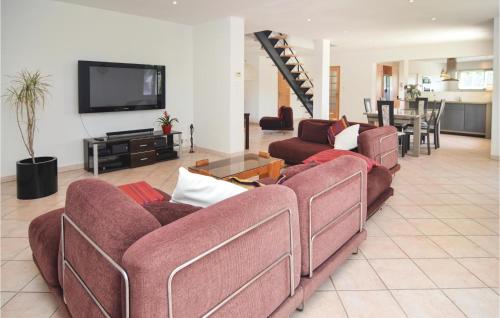 a living room with two couches and a flat screen tv at 4 Bedroom Beautiful Home In Calvisson in Calvisson