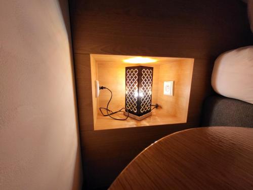 a small room with a light on the wall at Pension Jitřenka Hřensko - Breakfast Included & Free Parking in Hřensko