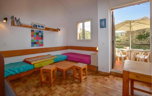 a room with a bed and a table and a window at 2 Bedroom Cozy Home In Grosseto-Prugna in Grosseto-Prugna