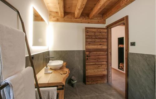 a bathroom with a sink and a wooden door at Beautiful Home In Castello Tesino With Kitchen in Castello Tesino