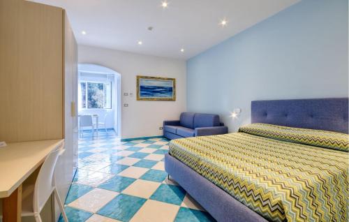 a hotel room with a bed and a chair at Lovely Apartment In Deiva Marina in Deiva Marina