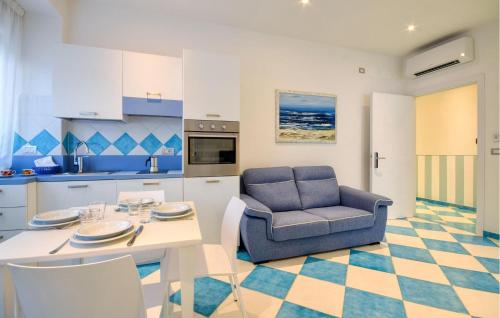 a kitchen and dining room with a table and a chair at Stunning Apartment In Deiva Marina in Deiva Marina