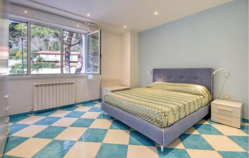 a bedroom with a bed and a checkered floor at Gorgeous Apartment In Deiva Marina in Deiva Marina