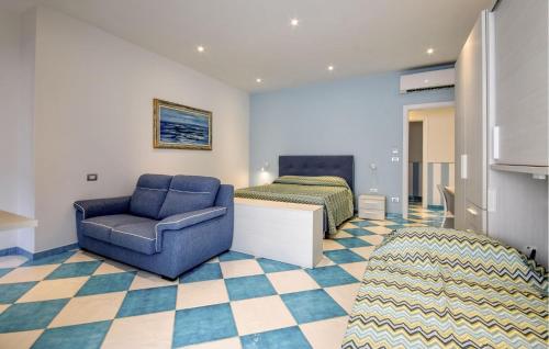 a room with a chair and a bed and a couch at Gorgeous Apartment In Deiva Marina in Deiva Marina