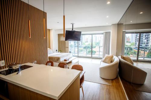 a living room with a couch and a living room with a bed at Habitarte - Studio Luxo Brooklin in Sao Paulo