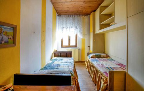 two beds are lined up in a room at Nice Apartment In Verni With Wifi in Verni