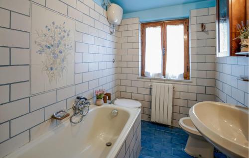a bathroom with a tub and a sink and a toilet at Nice Apartment In Verni With Wifi in Verni