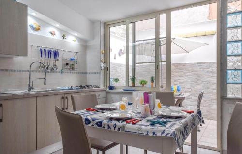 a kitchen and dining room with a table and chairs at Cozy Apartment In Mondello With Wifi in Mondello