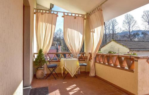 a balcony with a table and chairs on a balcony at Lovely Home In Camaiore With Wifi in Camaiore