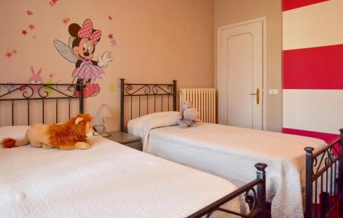 a bedroom with two beds and a dog laying on the beds at Lovely Home In Camaiore With Wifi in Camaiore
