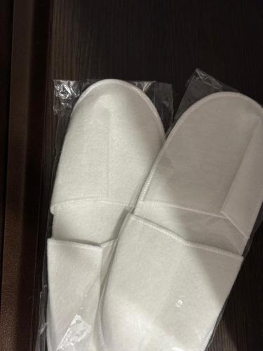 a pair of white shoes in a plastic bag at Dream town Apartaments біля залізничного вокзалу in Luts'k