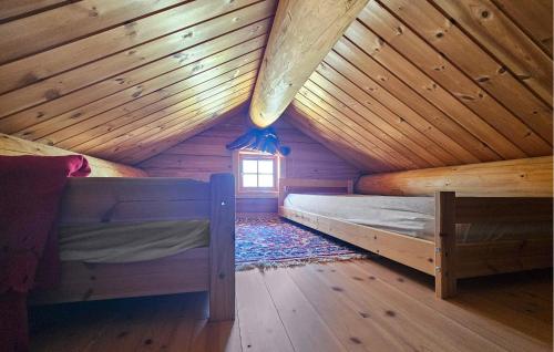 a room with two beds in a wooden cabin at 6 Bedroom Lovely Home In Treungen in Fjone