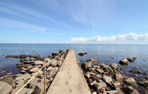 a pier in the water with rocks in the water at Awesome Home In Jonstorp With Wifi in Jonstorp