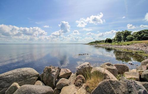 a large group of rocks on the shore of a lake at Awesome Home In Jonstorp With Wifi in Jonstorp