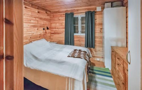 a bedroom with a bed in a wooden cabin at Nice Home In Kongsberg With Kitchen in Kongsberg