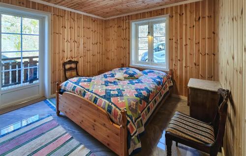 a bedroom with a bed in a room with wooden walls at Lovely Home In Stathelle With Wifi in Stathelle